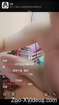 Asian girl is having fun with a a small green animal