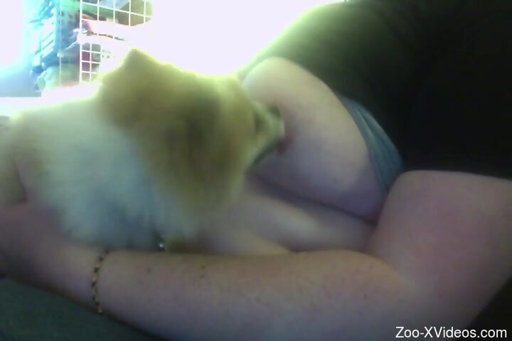 Busty amateur woman likes how her furry dog licks her nipples