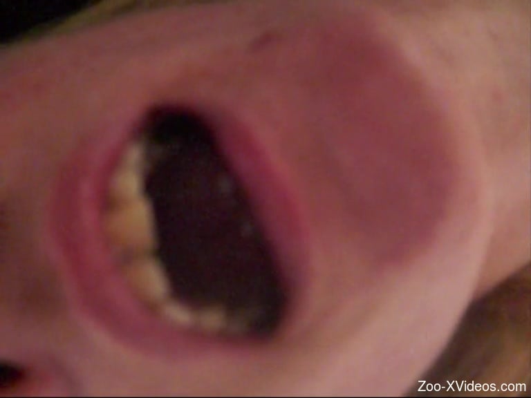 Woman spreads her mouth in a close up video