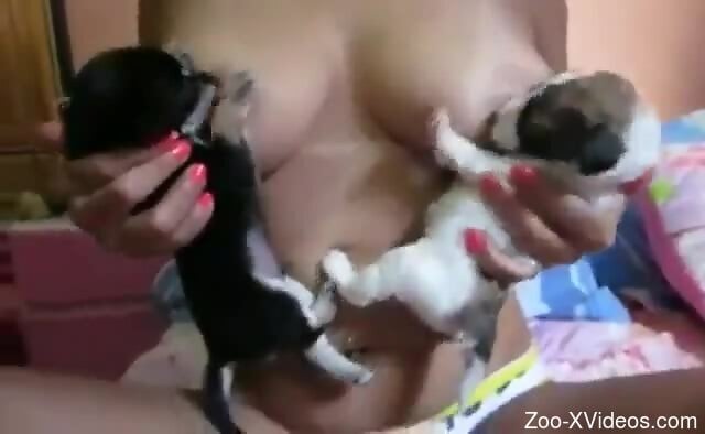 Naked woman lets young puppies suck her nipples in hot modes